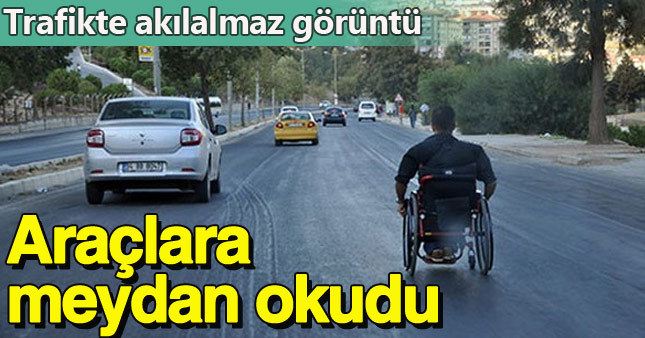 Tekerlekli sandalyeyle otomobilleri solladı